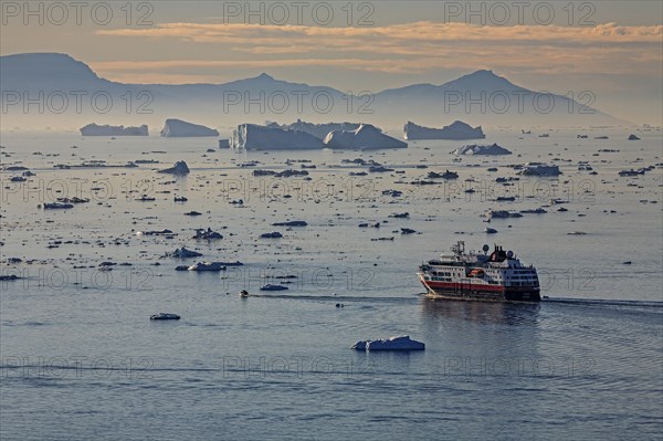 Hurtigruten ship in front of icebergs, reflection, midnight sun, summer, Ilulissat Icefjord, Disko