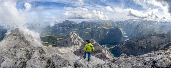 Mountaineer on the rocky summit of the Watzmann Mittelspitze, Watzmann crossing, view of mountain