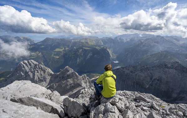 Mountaineer on the rocky summit of the Watzmann Mittelspitze, Watzmann crossing, view of mountain