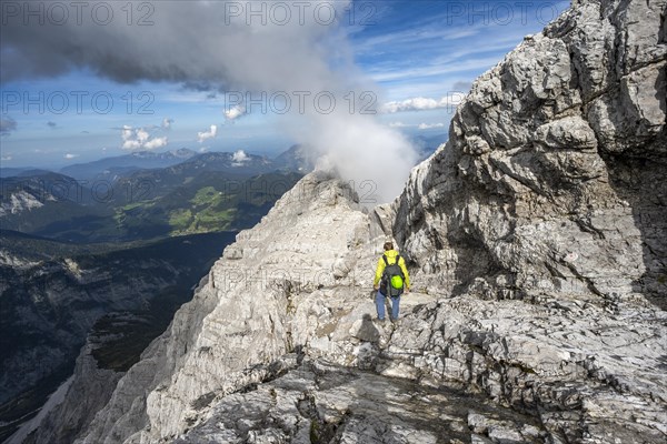 Mountaineer on a narrow rocky ridge, Watzmann crossing to Watzmann Mittelspitze, view of mountain