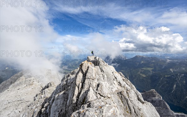 Mountaineer on the rocky summit of the Watzmann Mittelspitze, Watzmann crossing, view of mountain