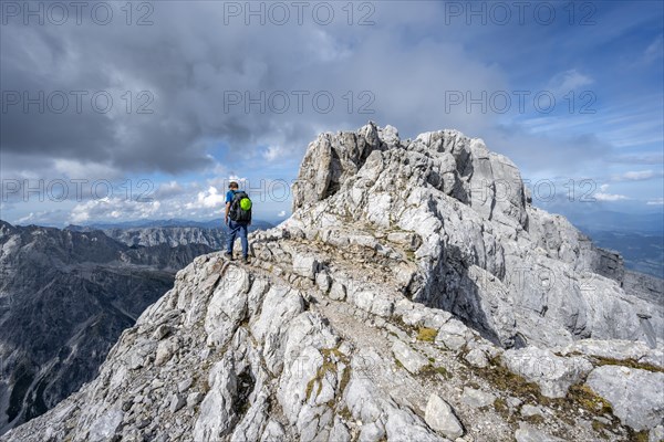 Mountaineer on a narrow rocky ridge, Watzmann crossing to the Watzmann Mittelspitze, Berchtesgaden