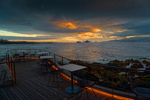 Terrace of the Cella Bar overlooking the coast of Madalena and the distant island of Faial at