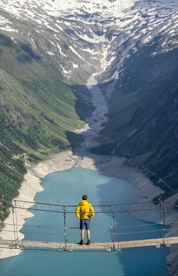 Mountaineers on a suspension bridge, picturesque mountain landscape near the Olpererhuette, view of