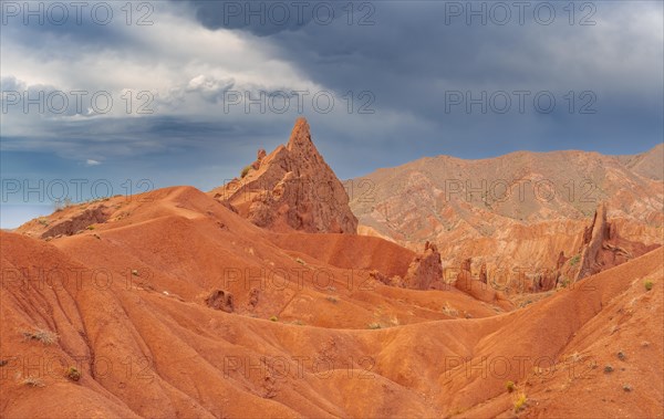 Eroded mountain landscape, sandstone cliffs, canyon with red and orange rock formations, Konorchek