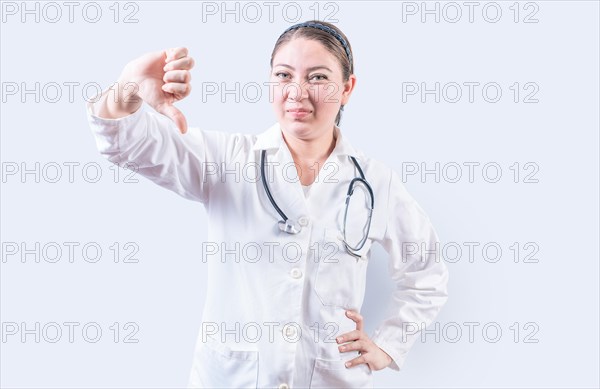 Female doctor gesturing disapproval isolated. Female doctor disapproving with fingers isolated