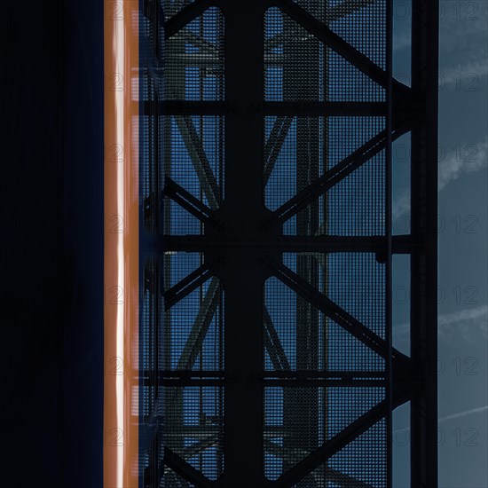 View of a dark, textured ceiling design with a mysterious orange light at the edge, suspension