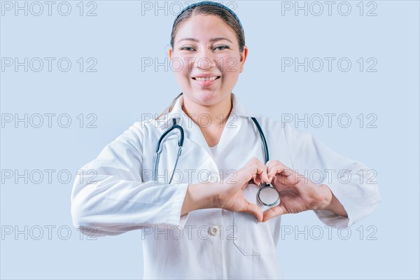 Smiling doctor making heart shape on isolated background. Friendly female doctor making heart