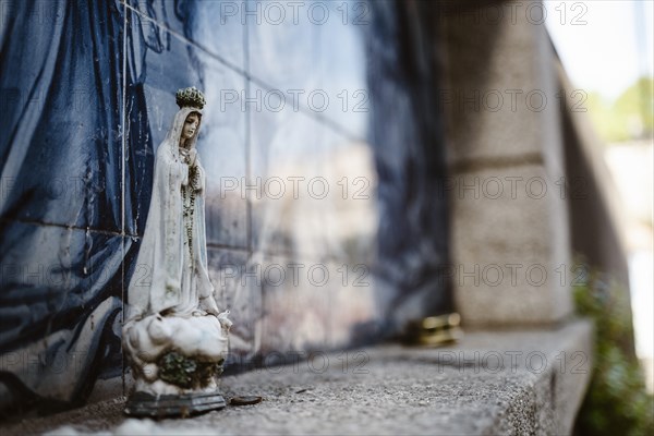 Holy Mary statue with the religious background made of Portuguese traditional tiles, Porto,