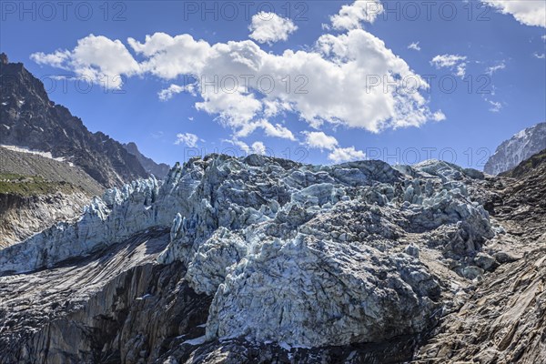 Glacier tongue at midday light in front of mountains, backlight, D'Argentiere glacier, Mont Blanc