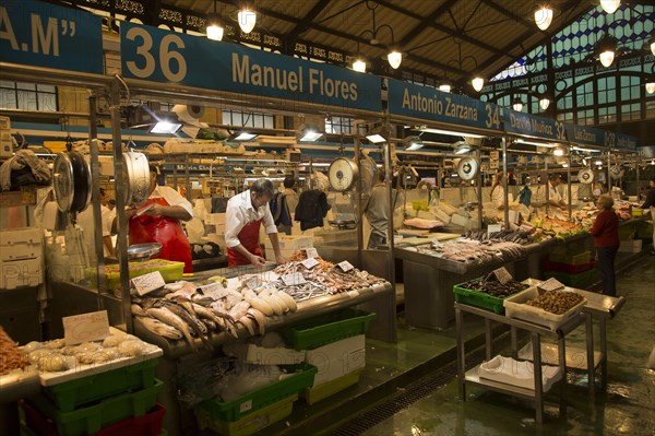 People shopping at fishmonger stalls inside historic covered market building, Jerez de la Frontera,