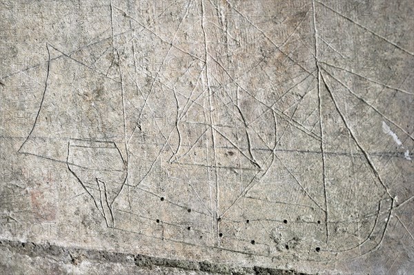 Old graffiti of galleon sailing ship carved on rampart wall of the citadel at Brouage,