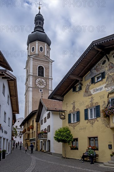 Alley in Castelrotto with the parish church of St Peter and Paul, Castelrotto, South Tyrol, Italy,