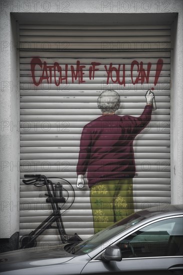 Garage door with graffiti of a man spraying 'Catch me if you can', Wuppertal Elberfeld, North