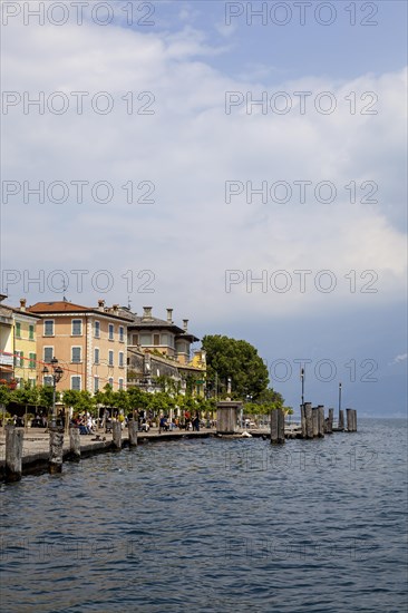 Waterfront promenade with restaurants in Gargnano, Lake Garda, Province of Brescia, Lombardy,