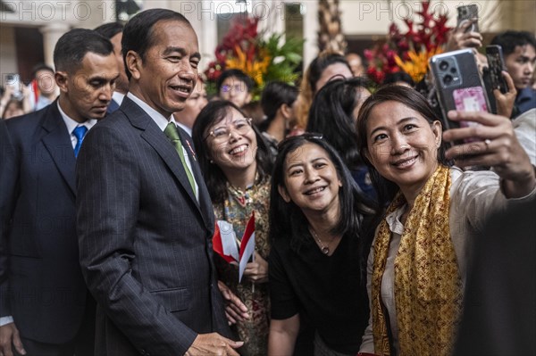 Joko Widodo, the President of Indonesia, takes selfies during a visit to Manila, Philippines