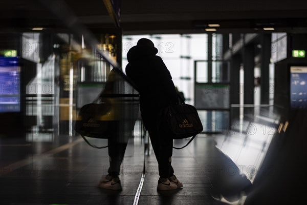 A person stands waiting at Berlin Central Station. Today is the second day of the strike by the