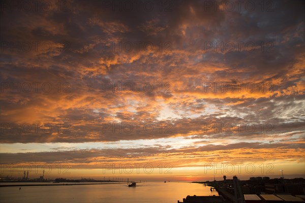 Sunset orange glow landscape clouds water, North Sea shipping, Port of Rotterdam, Hook of Holland,