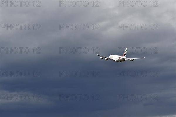 Emirates Airways Airbus A380-800 take-off in storm front with thundercloud, Munich Airport, Upper