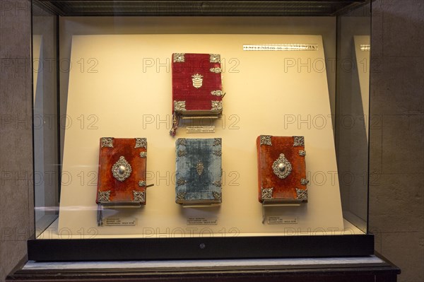 Glass display case of historic bible books inside the cathedral, former Great mosque, Cordoba,