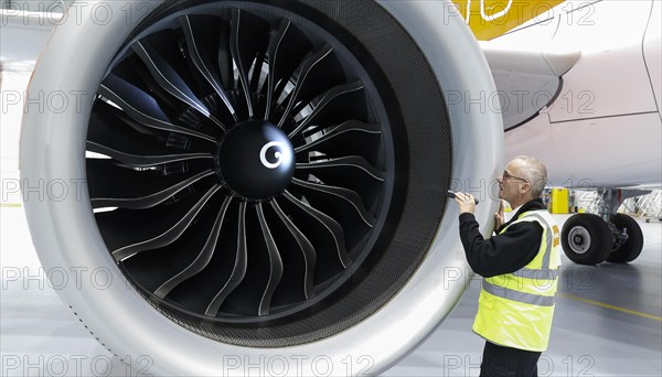 Olaf Gross, Licence Engineer at easyJet, checks the engine of an Airbus A320 Neo in front of the