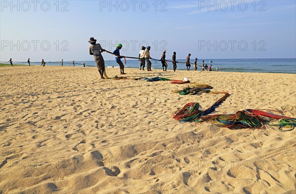 Traditional fishing hauling nets Nilavelli beach, near Trincomalee, Eastern province, Sri Lanka,