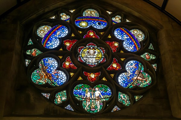 Stained glass window of Adam and Eve in Paradise, Roman catholic church of Saint John the