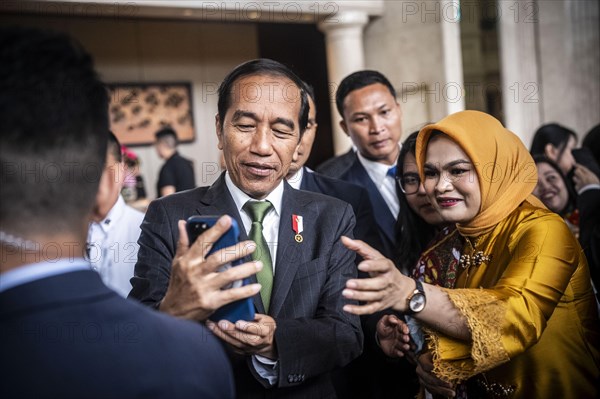 Joko Widodo, the President of Indonesia, takes selfies during a visit to Manila, Philippines