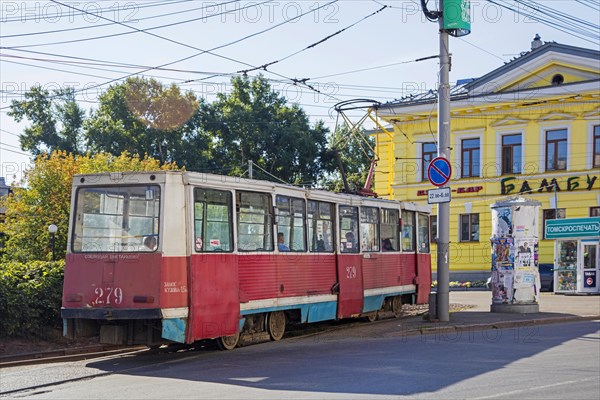 Red Russian tram KTM-5M3 71-605, Soviet streetcar in the city centre of Tomsk, Tomsk Oblast,