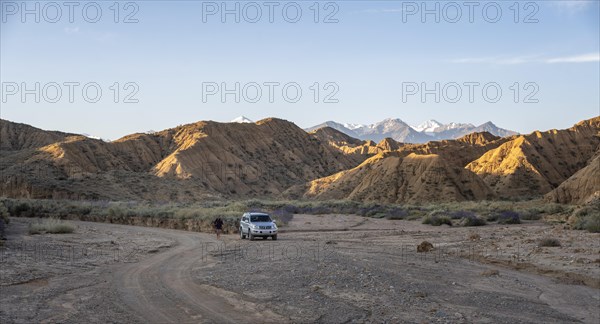Off-road vehicle on off-road road, eroded hilly landscape, Badlands, Valley of the Forgotten