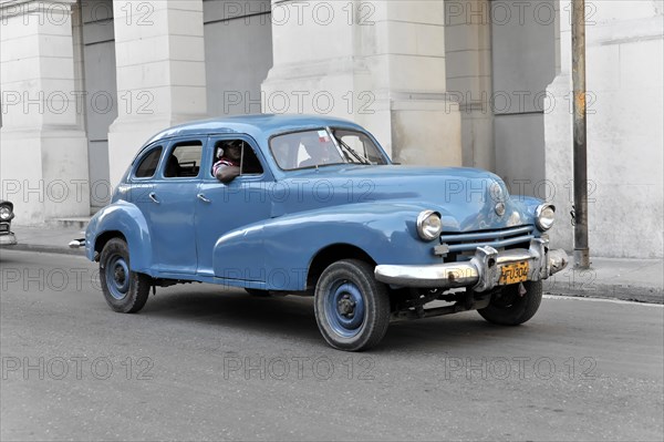 Blue vintage car from the 50s in Avenida Simon Bolivar, Calle Reina, centre of Havana, Centro