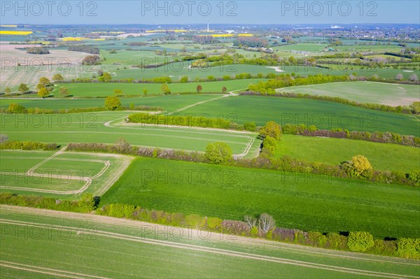 Aerial view over rural bocage landscape with fields and pastures, patchwork of plots surrounded by