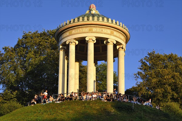 People enjoying the autumn sun at the Monopteros in the English Garden, Munich, Bavaria, Germany,
