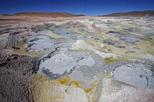 Mud lakes and steam pools with boiling mud in geothermal field Sol de Manana, Altiplano, Bolivia,