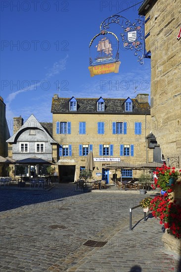 Rue du General de Gaulle in the old town centre of Le Faou with slate-roofed granite houses from