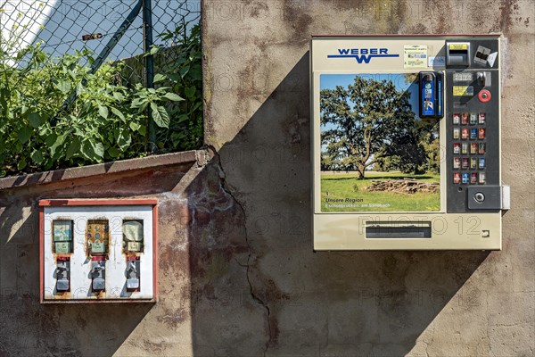 Chewing gum vending machine and cigarette vending machine together on a wall, vending machines for