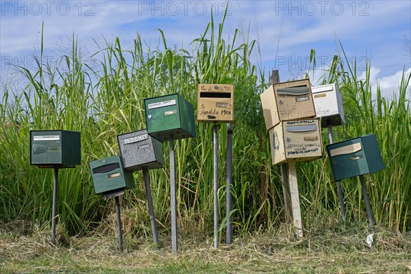Row of individual mail boxes, letter boxes, mailboxes, letterboxes, postboxes of residents on the