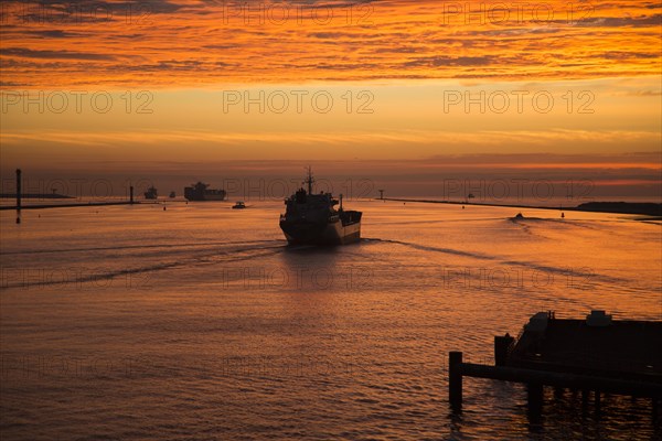 Sunset orange glow landscape clouds water, North Sea shipping, Port of Rotterdam, Hook of Holland,