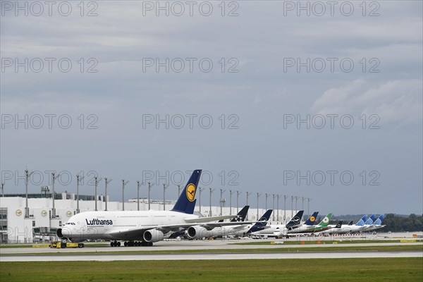 Lufthansa Airbus A380-800 in tow with push back truck in front of Terminal 2, Munich Airport, Upper