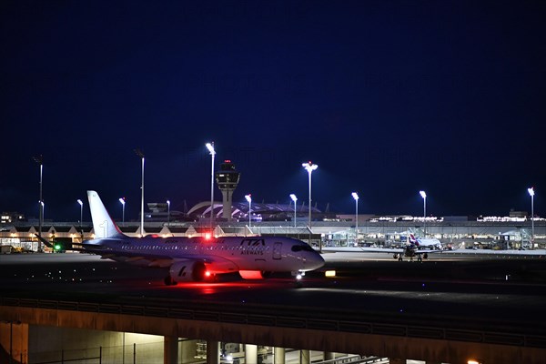 ITA Airways Airbus A220-300 taxiing on taxiway at night, Munich Airport, Upper Bavaria, Bavaria,