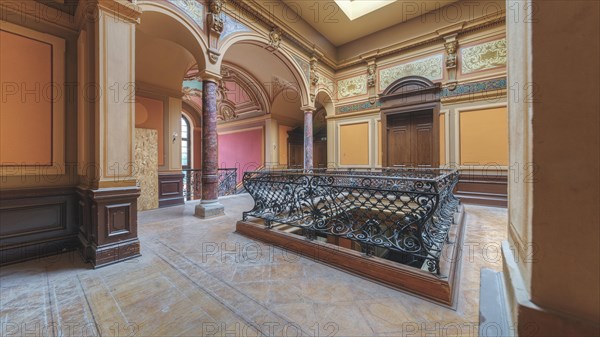 Elegant foyer with wrought-iron railings, columns and arches, luxurious interior design, Villa