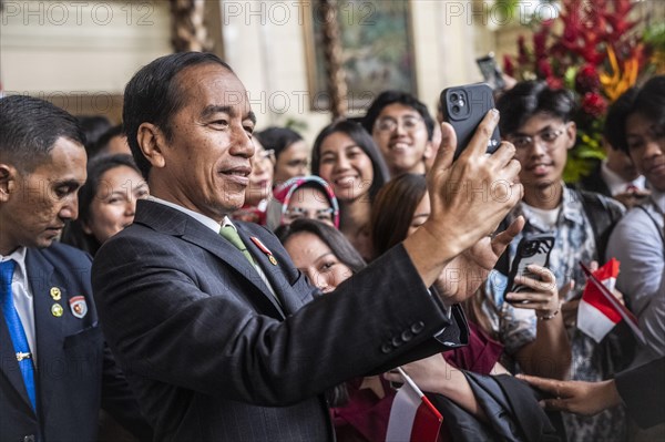 Joko Widodo, the President of Indonesia, takes selfies during a visit to Manila, Philippines