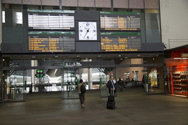 Electronic clock and display of travel information inside Santa Justa railway station, Seville,