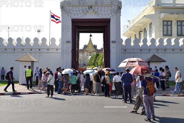 Crowds of tourists push through the entrance gate, Mani Nopparat Gate into the Grand Palace,