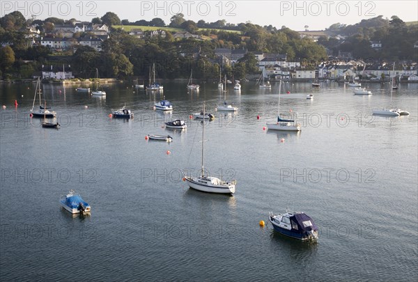 Yachts at moorings on River Fal, Flushing, Cornwall, England, UK