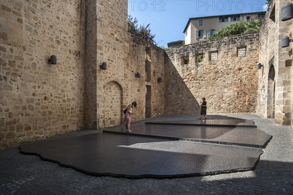 Tourists visiting giant replica of the Rosetta Stone that allowed Jean-Francois Champollion to