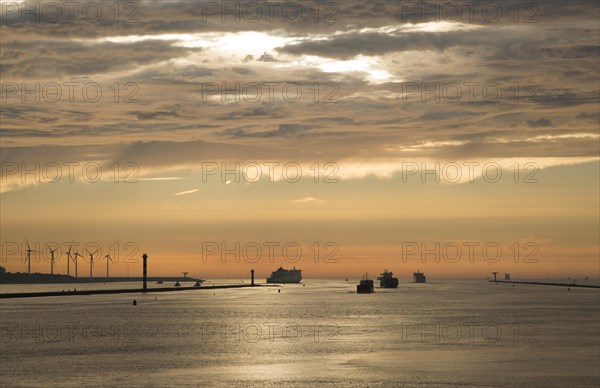 Sunset orange glow landscape clouds water, North Sea shipping, Port of Rotterdam, Hook of Holland,