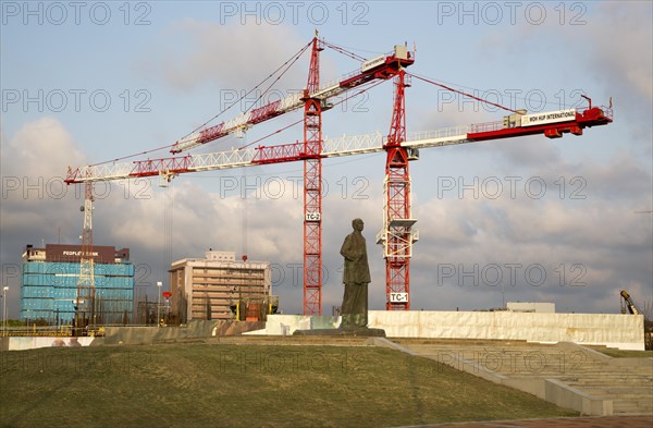 Cranes tower over statue of S.W.R.D. Bandaranaike at construction site in central Colombo, Sri