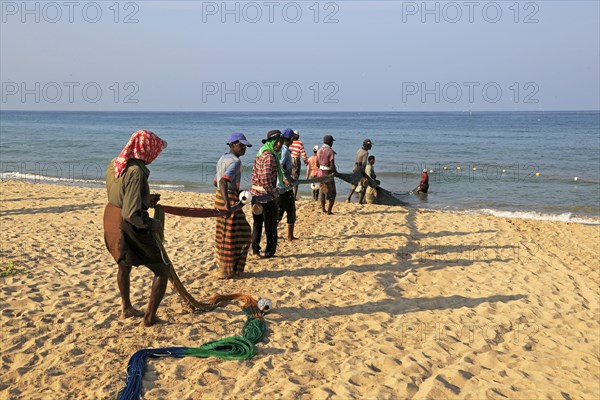 Traditional fishing hauling nets Nilavelli beach, near Trincomalee, Eastern province, Sri Lanka,