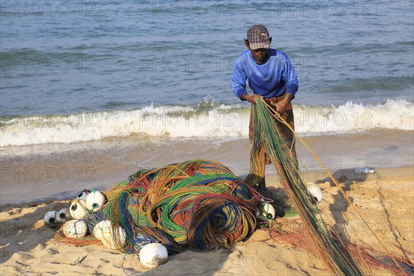 Traditional fishing hauling nets Nilavelli beach, near Trincomalee, Eastern province, Sri Lanka,